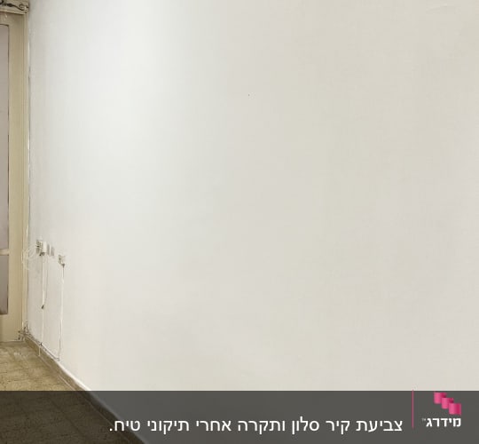 קיר צבוע לבן עם רצפת אריחים